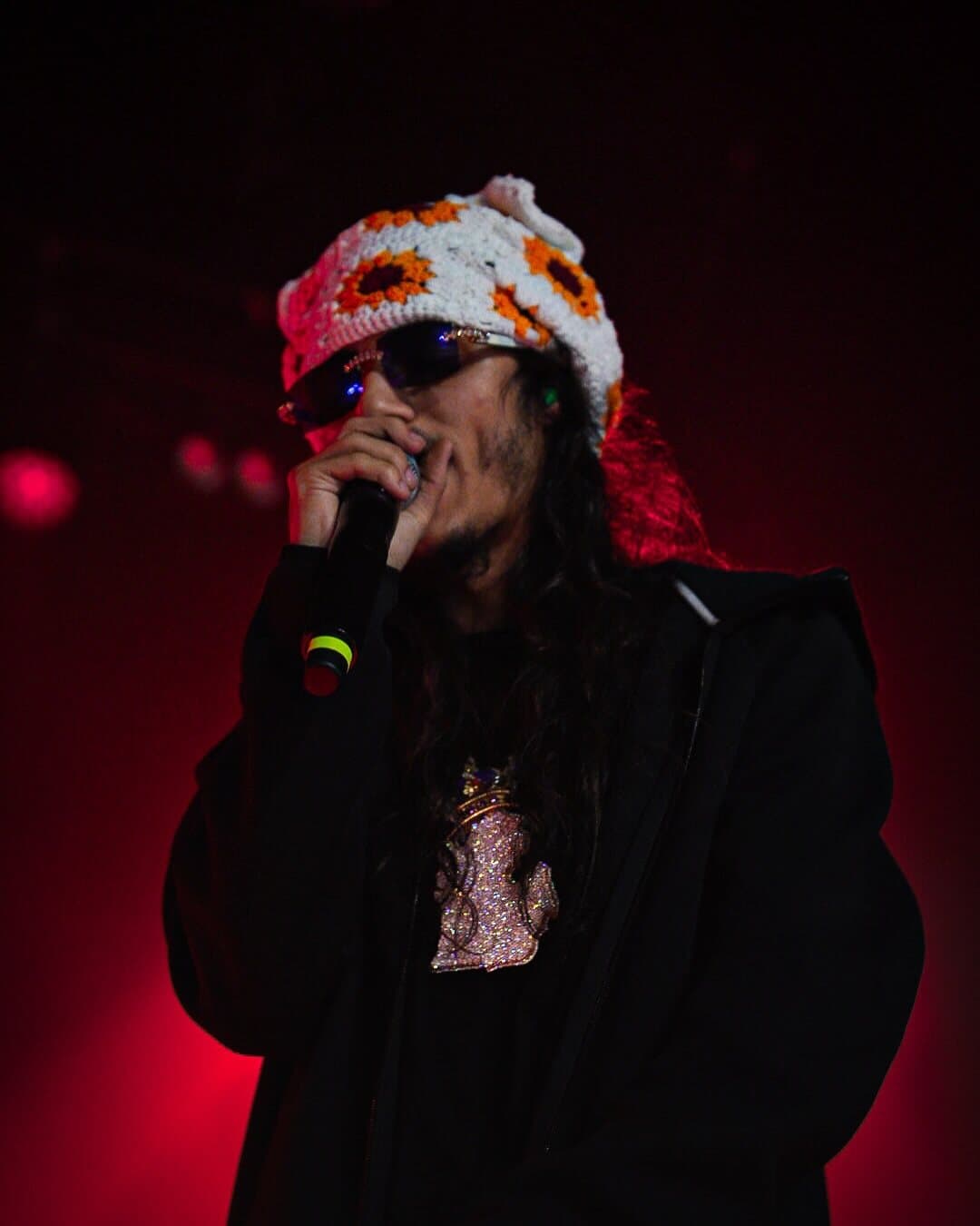 BabyTron in red light, mic in hand